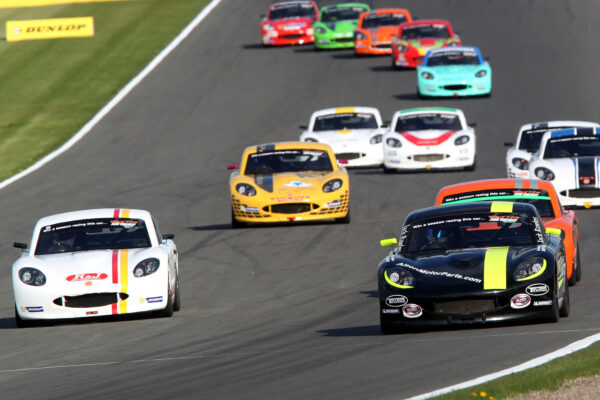 Jack Rawles leading a pack of juniors down the start finish straight at Donington