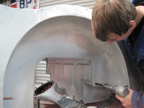 Bill Rawles builds a perfect under-body tub onto the chassis and hand-rivets perfectly finished outer panels onto it