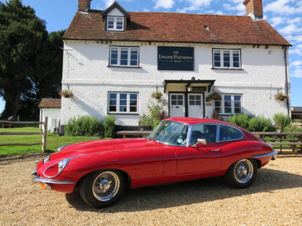 Jaguar E-Type Series 2. For sale at Bill Rawles Classic Cars Ltd. Red exterior and black trim running on chrome wire wheels just complements the whole appearance