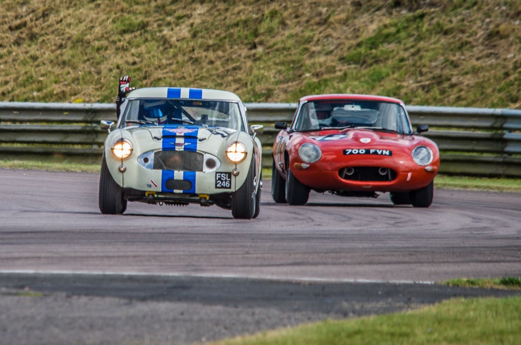 Jack Rawles, racing an Austin Healey 3000 has an exciting battle against a Jaguar E Type, during the penultimate lap of the Classic K series in the Classic Sports Car Championship at Thruxton race circuit, August 2016