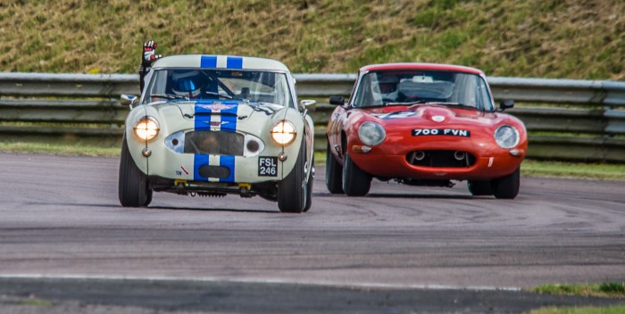 Jack Rawles, racing an Austin Healey 3000 has an exciting battle against a Jaguar E Type, during the penultimate lap of the Classic K series in the Classic Sports Car Championship at Thruxton race circuit, August 2016