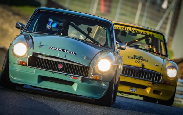 Jack Rawles, racing at Brands Hatch in his light green MGB V8. A thrilling race, showing Jack taking the lead from a yellow MGB V8.